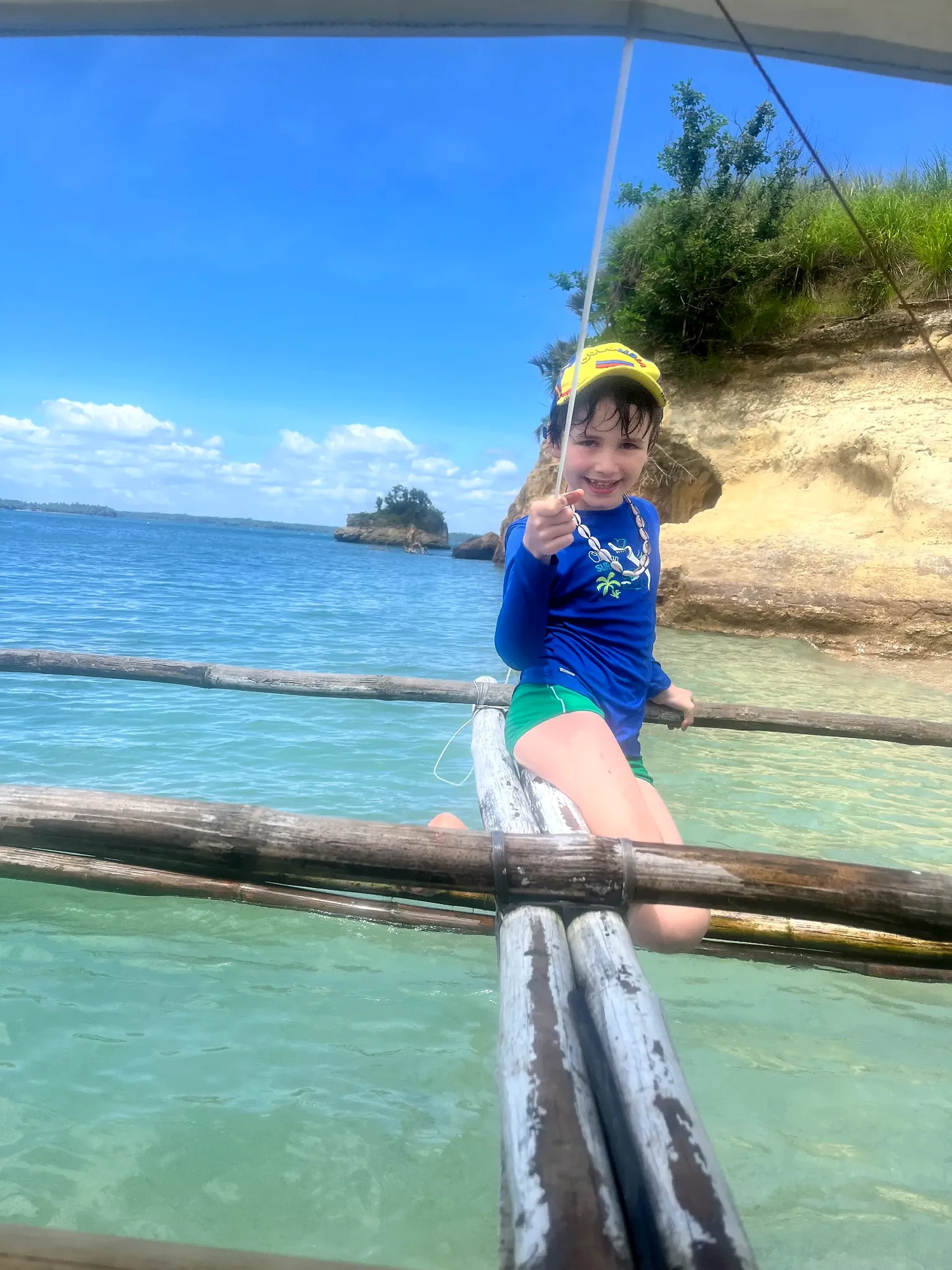 Child sitting on a bangka during island hopping in Pilar Bay