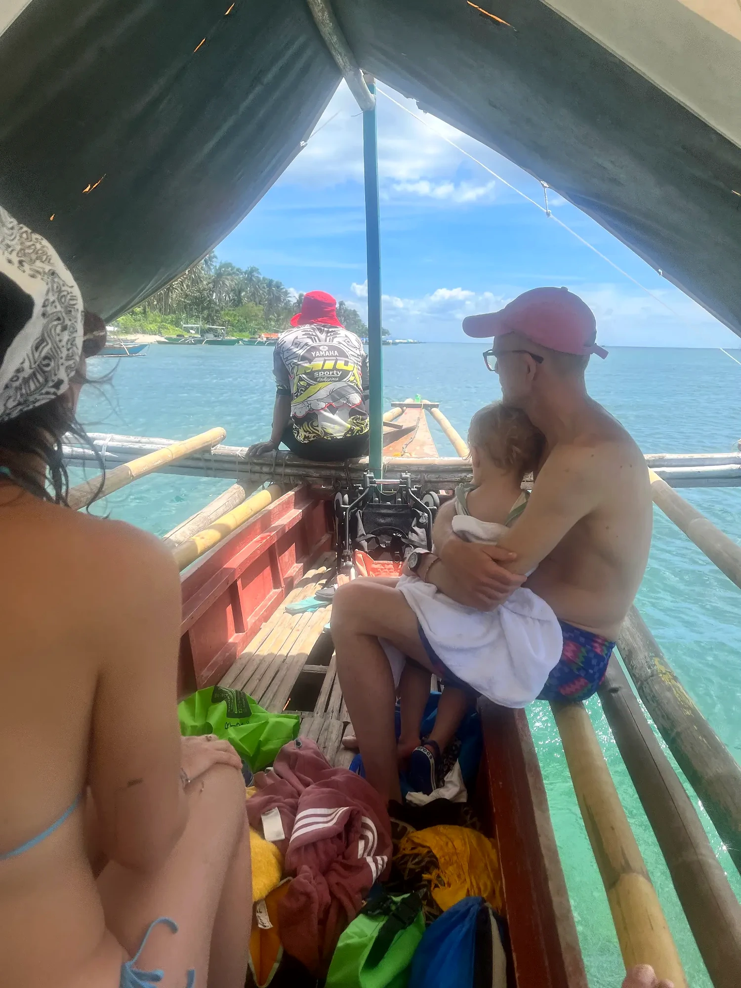 Family travelling by bangka during an island hopping trip in Pilar Bay, Sorsogon