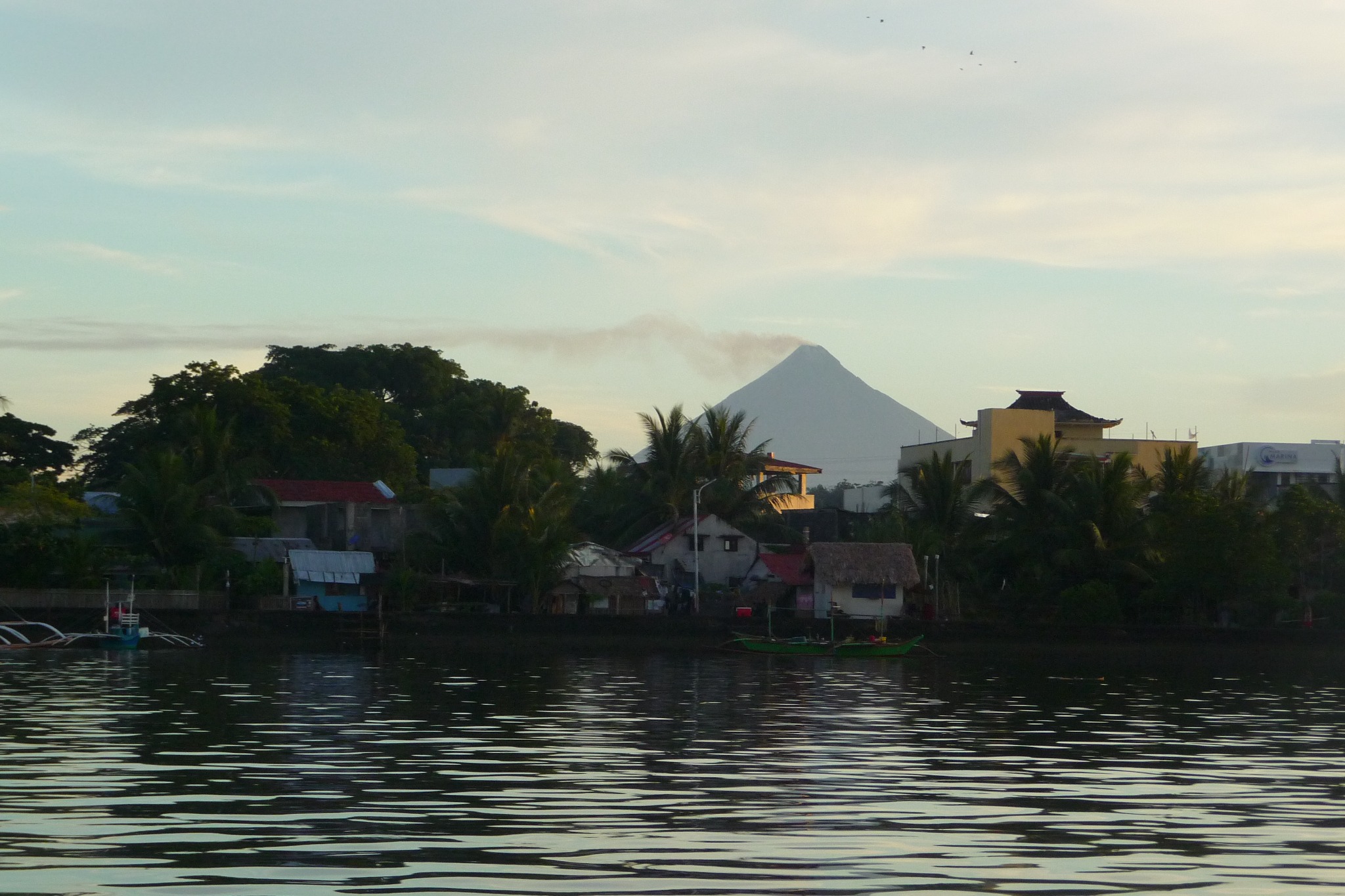 View across the water toward the village and volcanic landscape near Pilar, Sorsogon